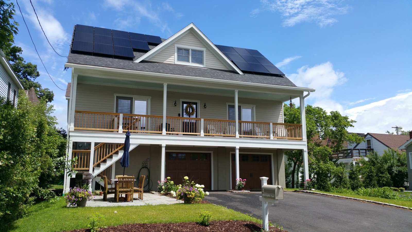 This house features an open-style layout with French doors facing south for natural light and views of the Sound and community tennis courts.