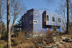 A home under construction, wrapped with a blue weather membrane